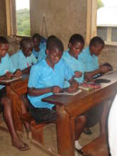Young boy helping make pads