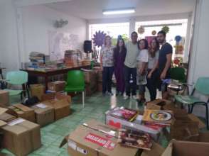 Volunteers help categorize 5000 library  books