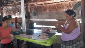 Dona Maria and her granddaughter make tortillas