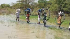 Carrying hoses and pumps.