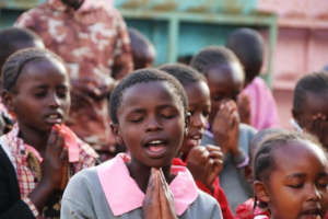 Saying prayers at Assembly