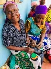 Grandmothers receiving donation of beans and maize