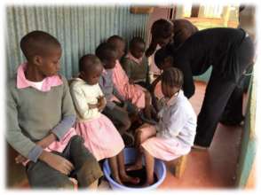 Timothy receiving treatment for jiggers at school