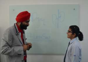 Doctor educating school kid on Salt