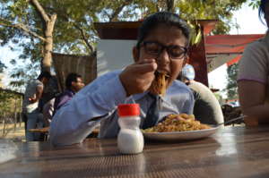 School kid eating noodles