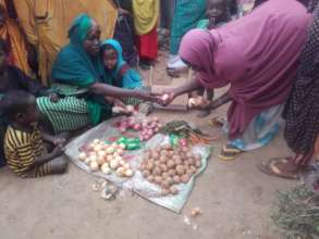 Uba and her children sell vegetables.