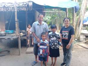 TLC team with students receiving study materials