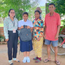 A student with family receiving studying material