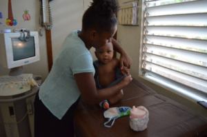 A young mother attends to her child