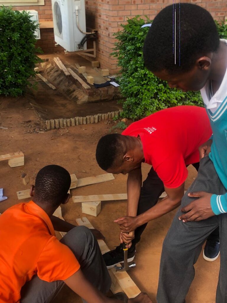 Facilitator removing nails from old crate-Safety!