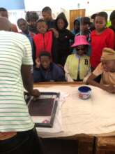 Facilitator showing how to print MOCHUDI