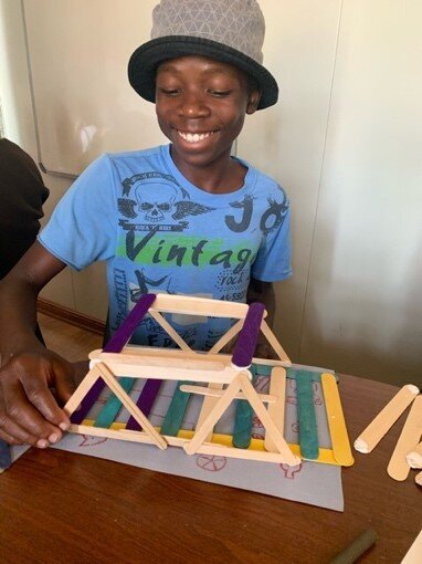 Happy Student showcasing completed bridge-Botswana