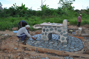 Project forman pouring the floor for the sink at schoolhouse.