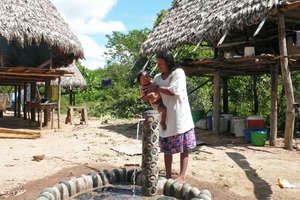 Matsigenka mother bathing her baby at her tap.