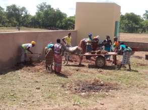 Mothers cleaning the yard of the new school