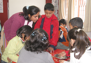 Ankur staff works with children at a Kathmandu school