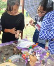 Girls explore clay and sand therapy at youth fair