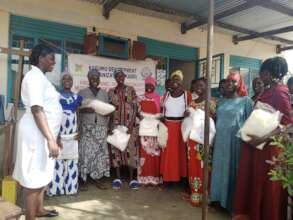 A pHOTO OF BENEFICIARIES WITH HEALTH WORKERS