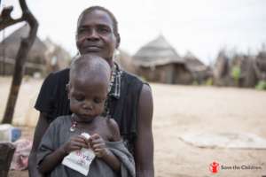 Lukan*, 3, poses for a picture with his mother