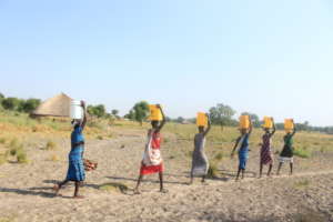 Women carrying water in buckets