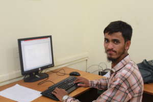 Bilal completing a task in computer class at PACC