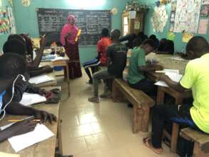 Sulayman studying with other talibes at MDG