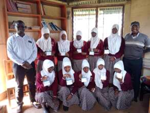 Girls receiving solar lamps