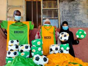 Teachers receiving balls and kit at one school Aug