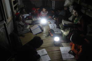 Students are reading by supported solar lamps