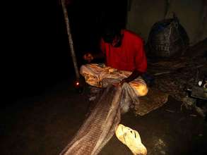 Fisherman are working  insufficient light