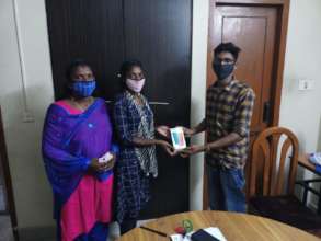 Don Bosco representative handing over the phone