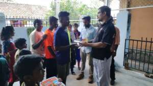 Child receiving a notebook from the Director