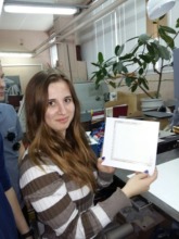 Katya shows her certificate from Tisso Printing