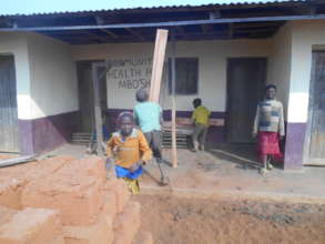 children welcoming buidling material at the h/c