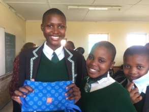 Happy South African school girls get their Kits.