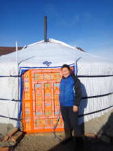 My dear mom stood in front of our new ger.