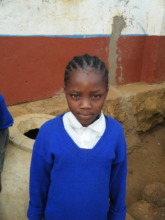 A child in front of her school