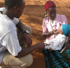 Child Receiving PlumbyNut from Nurse Nicholas