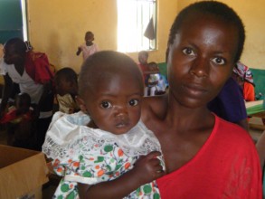 Mother and her child at a busy outreach clinic
