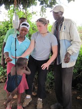 Volunteers weighing a child in the field