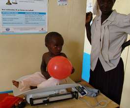 Weighing a child in Kisesini Clinic