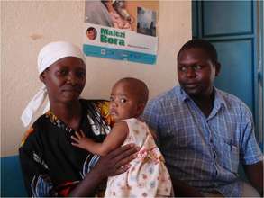 Nurse Nicholas Mutuku with a mother and child