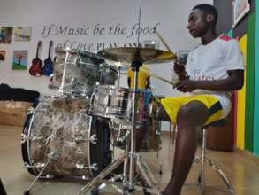 Samuel playing the drums