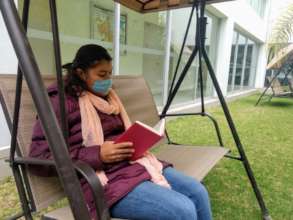 Jacqueline reading a book in our garden