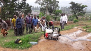 Voluteers and Rwampara staff with the sprinkler