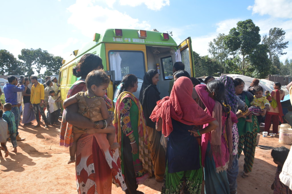 People in a slum waiting to meet the doctors