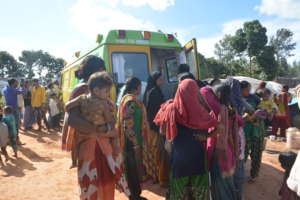 People in a slum waiting to meet the doctors