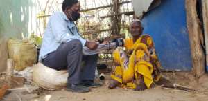 Healthcare worker monitors blood pressure
