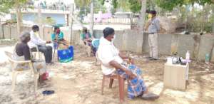 Munirajau clad in a white shirt at the centre