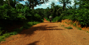 Farmer walking home on a  sandy road to Rochin